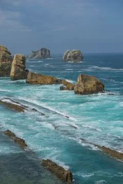 Rocks on the beach. Dramatic view of rocky coastline in Santander, Spain. Stock Photos