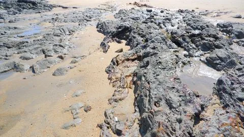 The Rocks On The Beach Have Been Eroded By Sea Water Stock Photos
