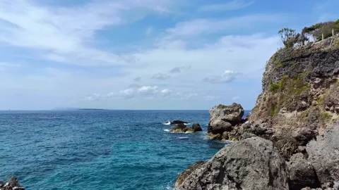 Rocks on the beach hit by ocean waves Stock Footage 296903425