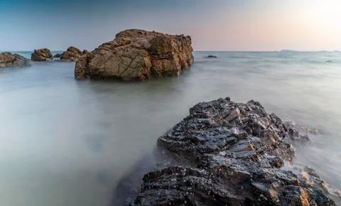 Rocks on beach, low angle view 스톡 사진