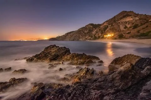 Rocks in the beach at night Stock Photos