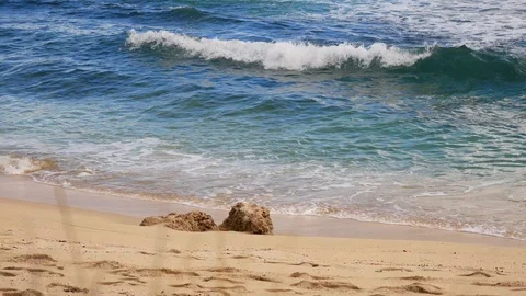 Rocks on a beach with waves crashing Stock Footage 91179188