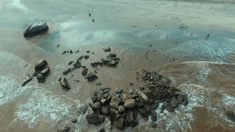 Rocks on a beach with waves  Stock Footage 142693520