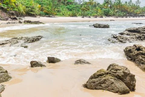 Rocks by the beach with waves splahes Stock Photos
