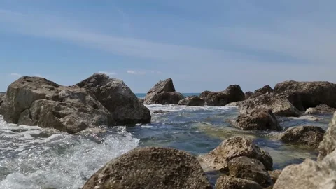 Rocks break the waves on the beach Stock Footage 183816507