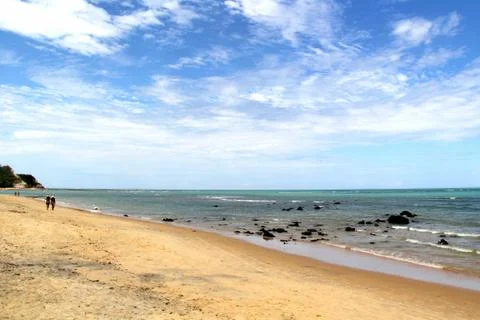 Rocks at a Calm Beach in a Bright Day Stock Photos
