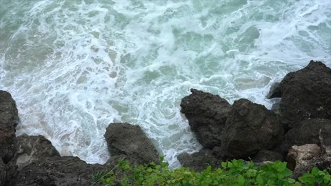 Rocks on a cliff and ocean waves top view Stock Footage 131176064