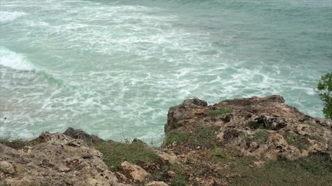 Rocks on a cliff and ocean waves top view Stock Footage 131176449