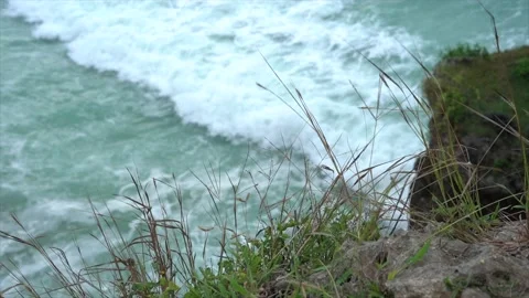 Rocks on a cliff and ocean waves top view Stock Footage 131176642