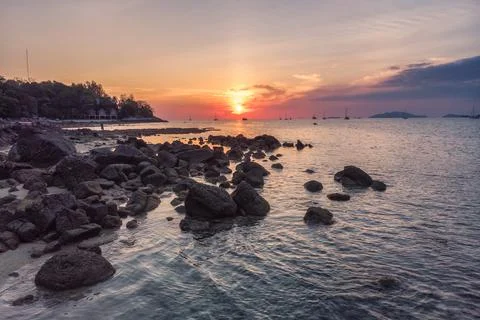 Rocks on coastline at sunset Stock Photos