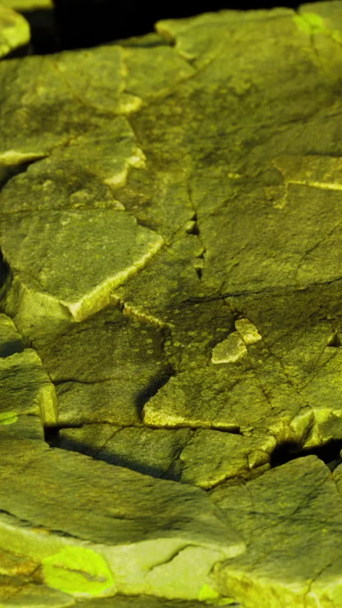 Rocks display green hues under light with visible texture in close up view Stock Footage 334183246