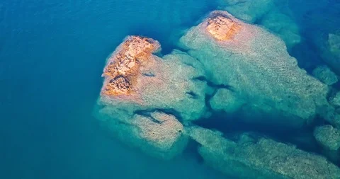 Rocks emerging from under the sea Stock Footage 108094624