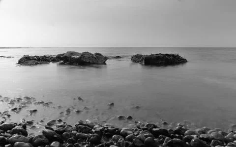 Rocks exposed by ebb tide Stock Photos