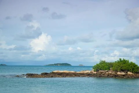 Rocks extending offshore. Stock Photos
