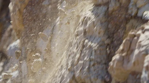 Rocks falling off a cliff and shattering on the walls Stock Footage