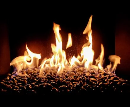 Rocks in fireplace with flames Stock Photos
