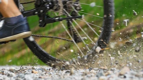 Rocks Flying When Cyclist Breaks Hard on Gravel Road Slow Motion Stock Footage 111056566