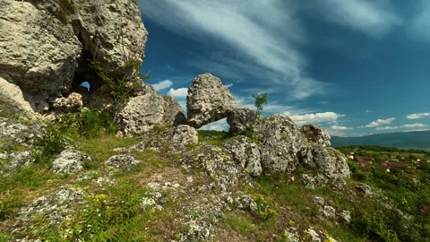 Rocks form a natural archway in a rugged landscape. Vrmdza Fortress. Serbia Stock Footage 338021117