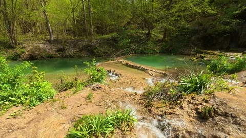 Rocks form natural steps along the stream's path. Balkan, Eastern Europe, POV 스톡 동영상 333589351