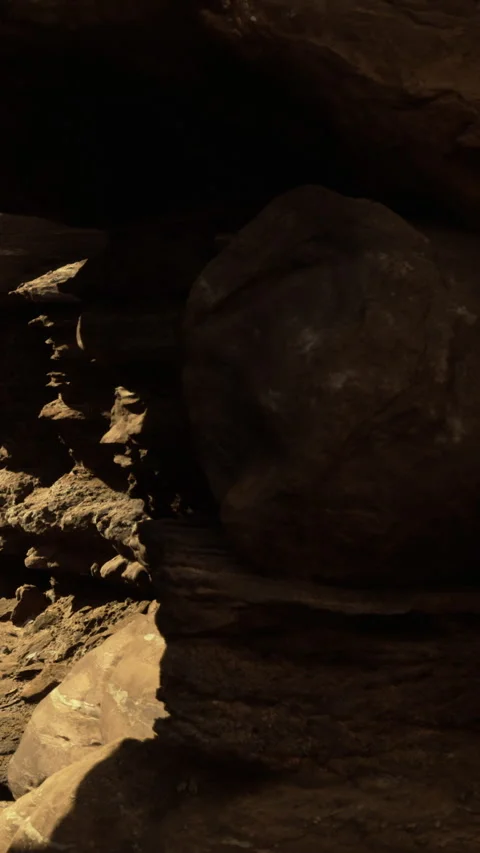 Rocks form shapes in cave during afternoon light in natural landscape Stock Footage 332206145