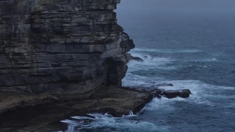 Rocks hit by large waves at the bottom of The Gap in Sydney slow motion 4K Stock Footage 265108058