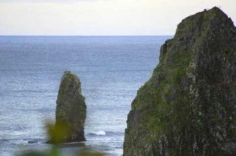 Rocks of the island of Kunashir. Stock Photos