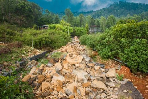 Rocks laid down to construct foundation for the new road in hilly region. Stock Photos