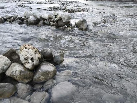 Rocks line a rushing riverbed Stock Photos