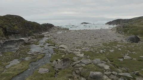 Rocks, Moss, and Streams Leading to Ocean Near Ilulissat Stock Footage 292941410
