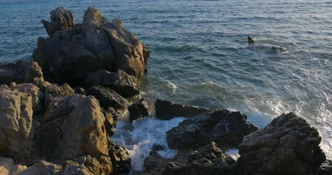 Rocks mountains waves at sunset Stock Footage 221834868