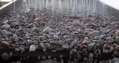 Rocks move through vibrating screen, screening and washing in open-pit mining Stock Footage 289201556