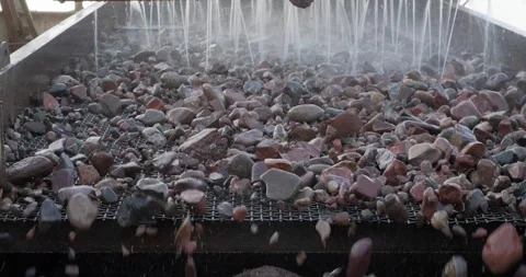 Rocks moving through vibrating screen. Screening and washing in open-pit mining Stock Footage 292299781