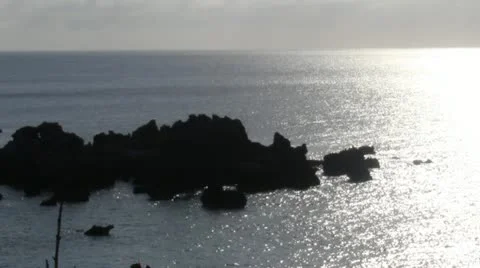 Rocks in the ocean at sunset Stock Footage 12423313