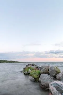 Rocks by Ocean at Sunset Stock Photos