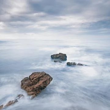 Rocks in a ocean waves under cloudy sky. bad weather. Stock Photos