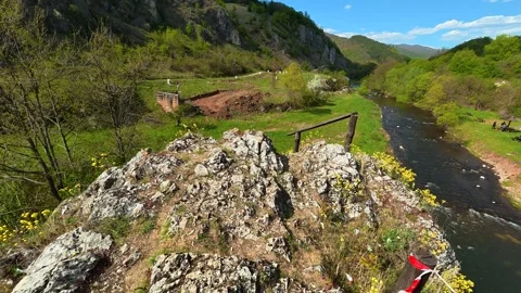 Rocks overlook a river winding through green hills. Balkan, Eastern Europe, POV Stock Footage 333590324