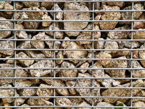Rocks Packed Behind Wire Mesh Grid Stock Photos