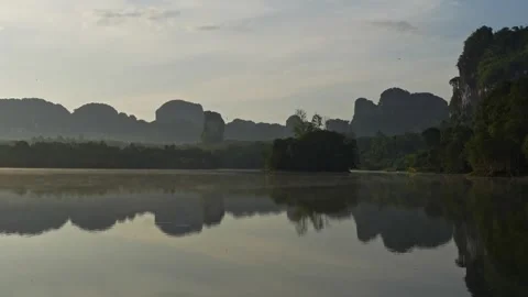 Rocks by a quiet river, mountain reflections in the water, mirror-like surface Stock Footage 254280638