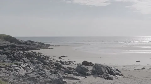 Rocks on a quiet sunlit beach Stock Footage 159421456