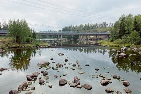 Rocks in rapids and bridge. Stock Photos