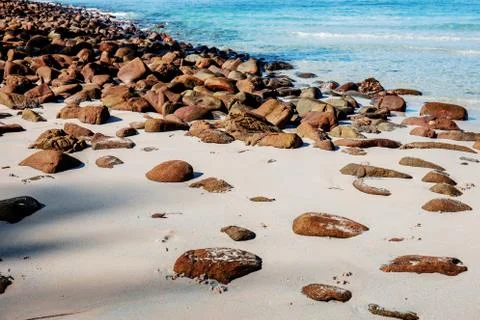 Rocks on sand with sunlight. Stock Photos