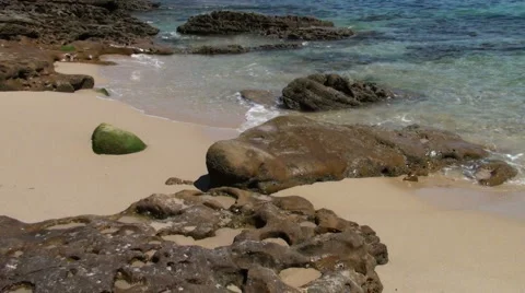 Rocks on a sandy beach at the sea shore Stock Footage 907595