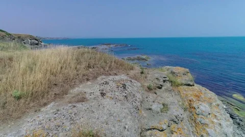 Rocks, sea and dry grass Stock Footage