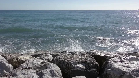Rocks sea waves blue sky Stock Footage 74581834