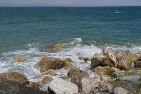 Rocks in the sea with waves Stock Photos