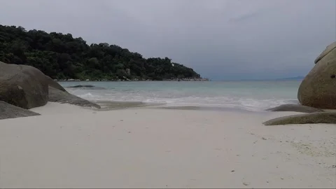 Rocks in shallow turquoise water on white sandy beach, Perhentian Island Video stock 199584843