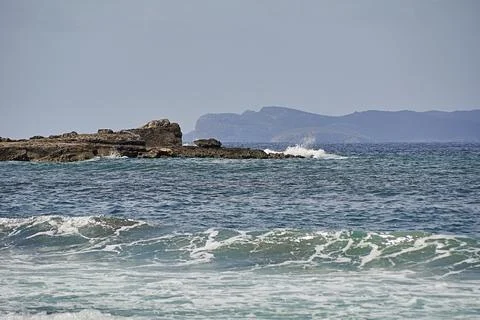 Rocks on the shore hit by the wave Stock Photos