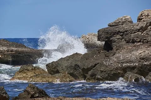 Rocks on the shore hit by the wave Stock Photos