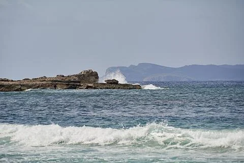 Rocks on the shore hit by the wave Stock Photos