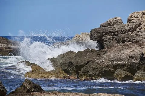 Rocks on the shore hit by the wave Stock Photos